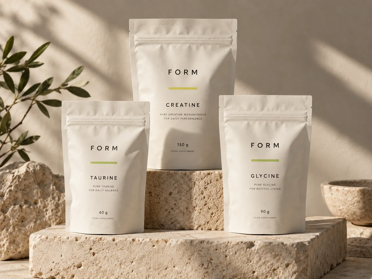 Individual FORM creatine, taurine and glycine pouches on limestone